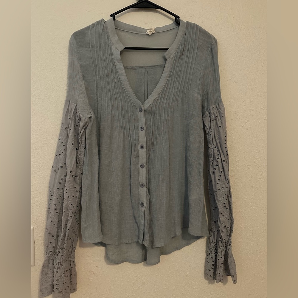 Light blue, button up top with cute sleeve detail. Size medium